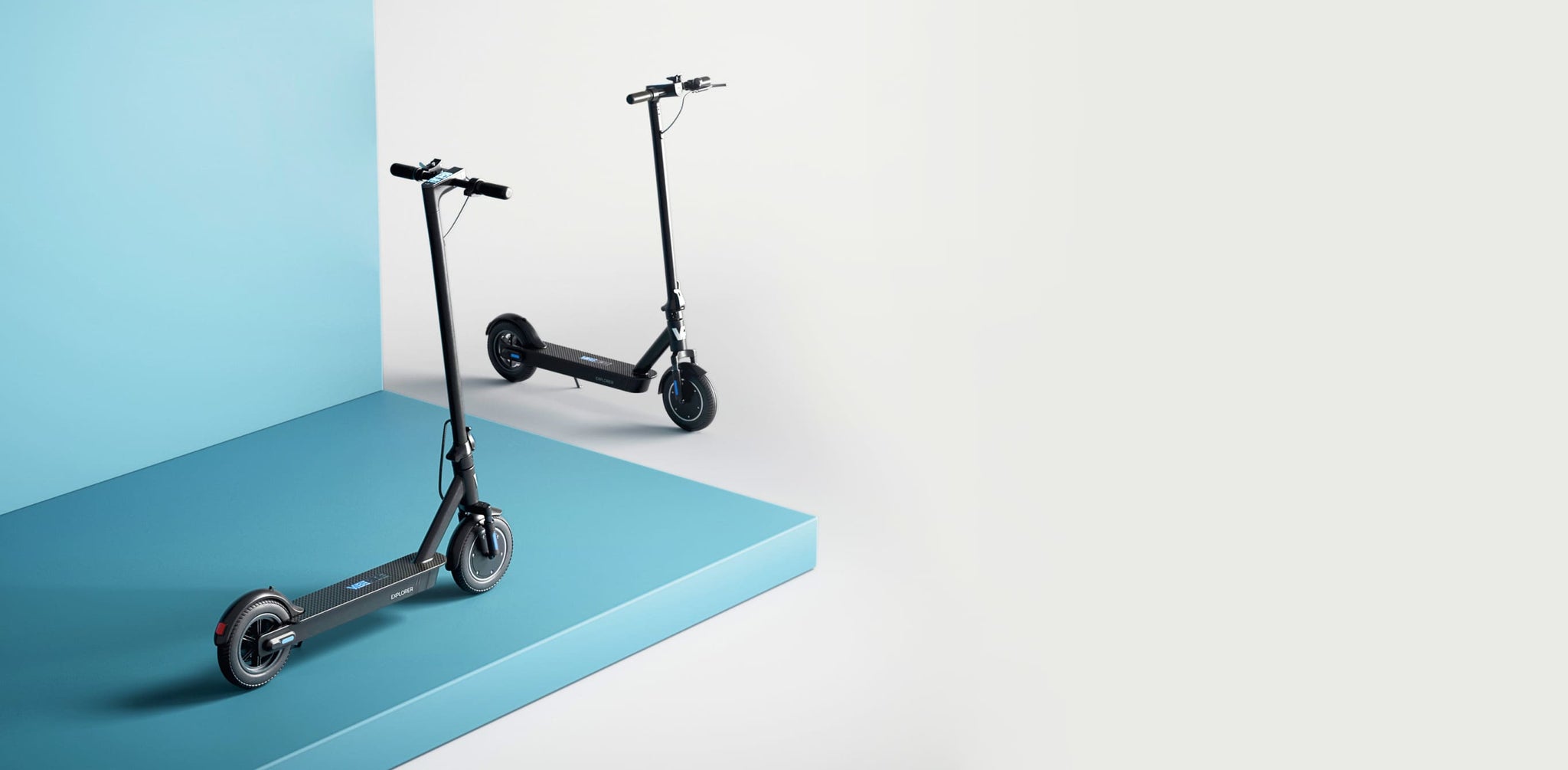 Two premium electric scooters in a product studio